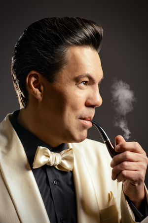 Imposing mature man with a haircut in the style of the 60s.の写真素材