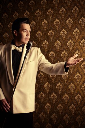 Handsome male singer, who plays in the style of the sixties. Rock'n'roll, jazz man. Nostalgia.の写真素材