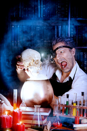 Portrait of a crazy medieval scientist working in his laboratory.の写真素材