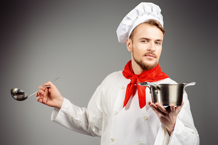 Chef tries cooked soup. Occupation. Studio shot.の写真素材