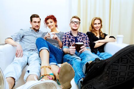 Happy smiling young people spending time together at home. Weekend with friends. Celebration. Birthday.の写真素材