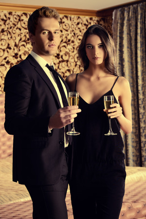 Beautiful man and woman in elegant evening clothes in classic vintage apartments. Glamour, fashion. Love concept.の写真素材