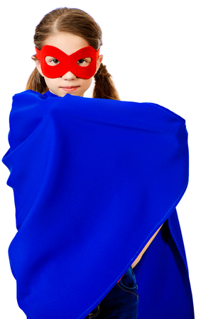 Cute girl teenager in a costume of superhero. Isolated over white background.の写真素材