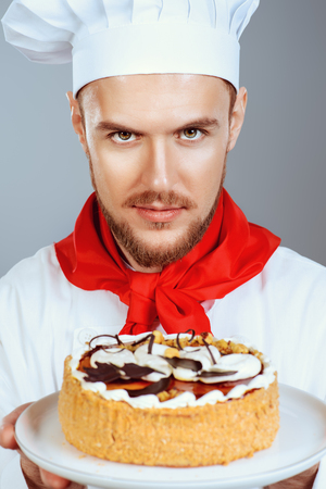 Portrait of a male confectioner cooking a delicious cake.の写真素材