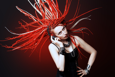 Expressive girl rock singer with great red dreadlocks.の写真素材