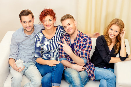 Happy smiling young people spending time together at home. Weekend with friends. Celebration....