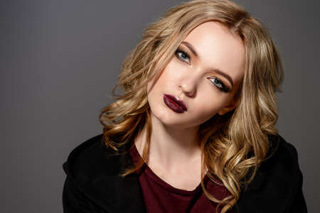 Attractive fashion girl with dark make-up posing in black clothes.の写真素材