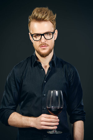 Male sommelier tasting red wine. Winemaking. Occupations.の写真素材
