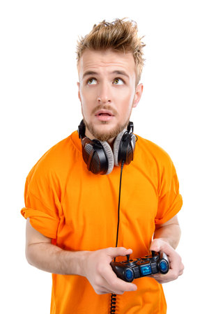Crazy gamer with controller and headphones. Isolated over white.