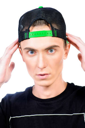 Modern young man in a baseball cap. Teenager. Isolated over white.の写真素材