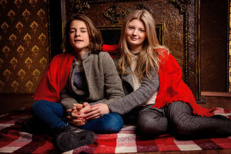 Two romantic young people spending evening together by the fireplace.の写真素材