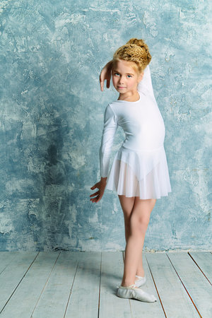 Beautiful young ballet dancer posing in studio.の写真素材