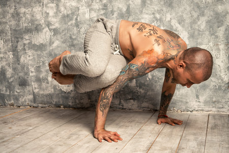 Yoga concept. Experienced yoga master performs different poses and exercises. Studio shot.