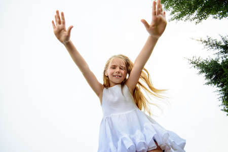 Laughing girl enjoys her childhood. Happy childhood.の写真素材