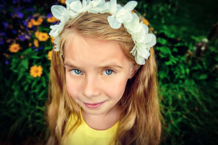 Cute laughing girl has fun at a summer park. Happy childhood. Summer holidays.の写真素材