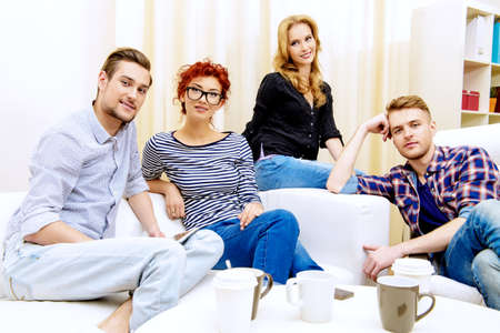 Happy smiling young people spending time together at home. Weekend with friends. Celebration. Birthday.の写真素材