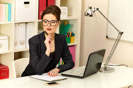 Businesswoman working at the office. Business, education.の写真素材