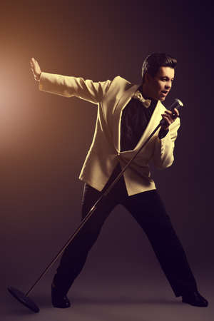 Handsome male singer, who plays in the style of the sixties. Rock'n'roll, jazz man. Nostalgia.の写真素材