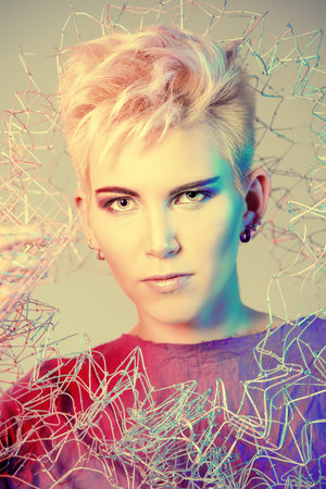 Close-up portrait of a fashion model performing designer collection with the use of metal wire....