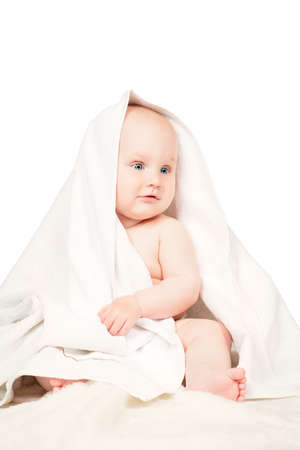 Sweet baby in a towel after bath. Healthcare, pediatrics. Isolated over white.の写真素材