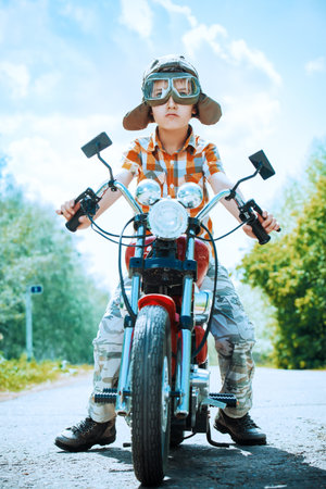 Handsome boy go on a journey on a motorcycle. Adventure. Summer holidays. Active lifestyle.
