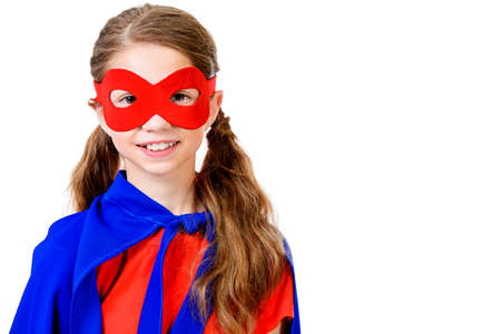 Cute girl teenager in a costume of superhero. Isolated over white background.の写真素材