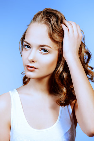 Beautiful young woman with natural clear face. Perfect skin. Nude make-up, cosmetics.