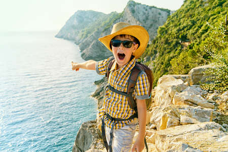 Happy boy spends the summer holidays at the seaside. Outdoor activities, tourism and adventure.の写真素材