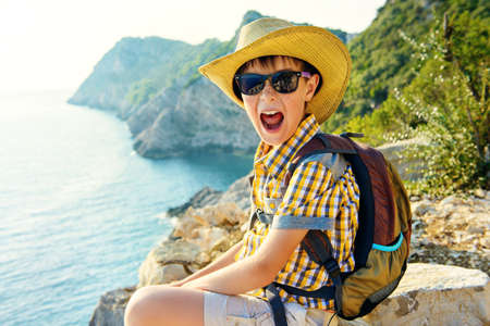 Happy boy spends the summer holidays at the seaside. Outdoor activities, tourism and adventure.の写真素材