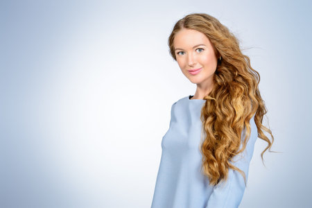 Portrait of a tender romantic girl with beautiful long wavy hair. Beauty care concept. Natural...