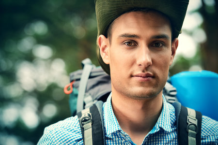 Adventure concept. Young man hiking in the forest. Active lifestyle, tourism. Tourist equipment.