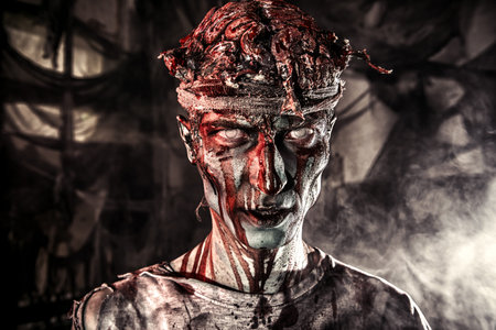 Bloody zombie man with brains out. Horror. Halloween.