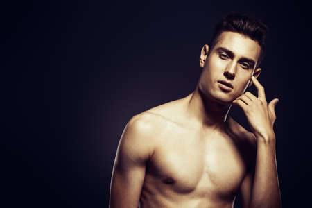 Portrait of a sexual young man with muscular body. Men's health, beauty.の写真素材