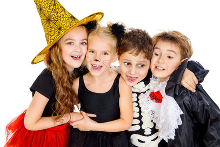 Portrait of a cute laughing children in halloween costumes. Halloween concept. Isolated over white.