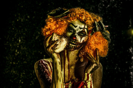 Close-up portrait of a terrible bloody clown with a mask. Halloween. Horror.の写真素材