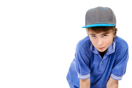 Portrait of a smiling teenage boy. Studio shot. Teen fashion. Isolated over white. Copy space.