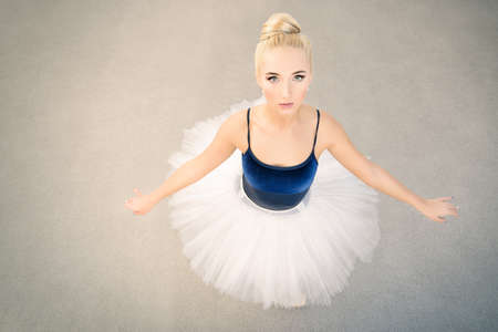 Ballet concept. Portrait of a beautiful graceful ballerina wearing tutu and pointe shoes.の写真素材