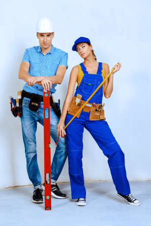 Male and female construction workers. Smiling young couple in love is going to renovate their new apartment. Copy space.の写真素材