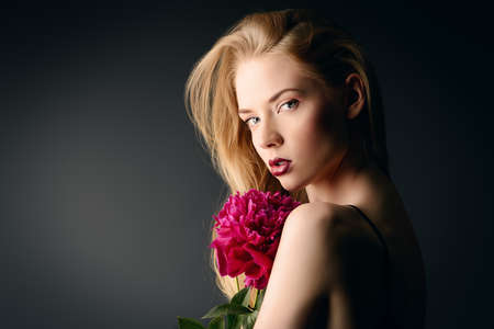 Portrait of a gorgeous blonde woman with sensual maroon lips. Beauty, fashion. Make-up, cosmetics.の写真素材