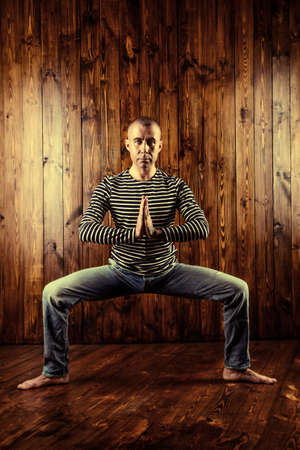 An experienced yoga instructor showing different yoga poses. Brick wall background. Healthy lifestyle. Meditation, concentration.の写真素材