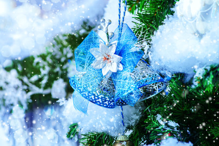 Christmas bells on snow-covered tree.の写真素材
