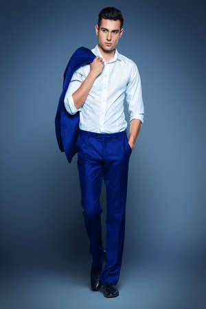 Vogue shot of a handsome male model in elegant classic suit. Men's beauty, fashion. Full length portrait.の写真素材