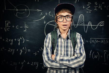Education, high school, college. Portrait of a funny emotional student boy standing by a school...