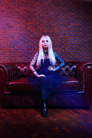 Portrait of an extravagant attractive woman with bright make-up and long blonde hair. Beauty,...