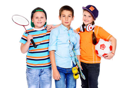 Sports and activities for children. Group of happy boys and a girl posing at studio. Education. Isolated over white background.の写真素材