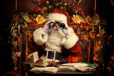 Santa Claus is preparing for Christmas, he looks through binoculars. House of Santa Claus. Christmas decoration.の写真素材