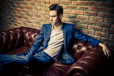 Imposing well dressed man in a luxurious apartments with classic interior. Luxury. Men's beauty, fashion.の写真素材