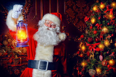 Christmas concept. Portrait of a fairytale Santa Claus standing with lantern in a beautiful...