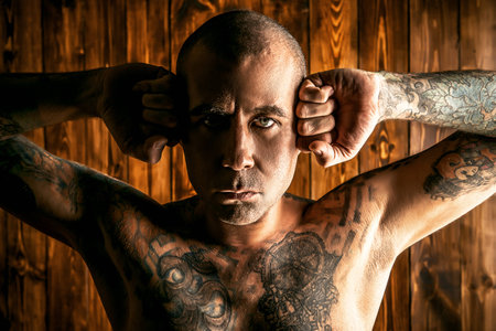 Yoga concept. Emotional yoga. Mature man doing yoga exercises and meditation over wooden background.の写真素材