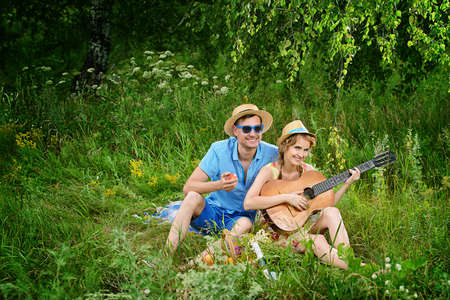 Beautiful young people in love enjoy their summer picnic.の写真素材